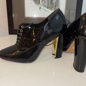 Pour La Victoire Black Patent Heels with Gold Accents